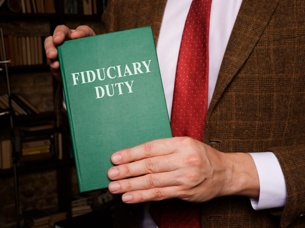 Attorney reviewing fiduciary duty contract in New York.